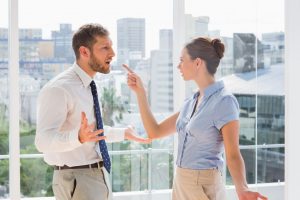 Two employees, one employee confronting another over sexual harassment