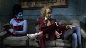 Beetlejuice in a waiting room touching a womans' leg, Halloween Monsters and Ghoulish Safety