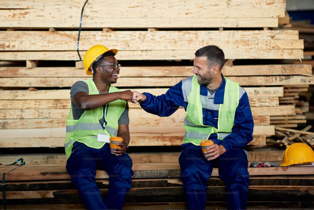 Two laborers bumping fist