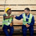 Two laborers bumping fist